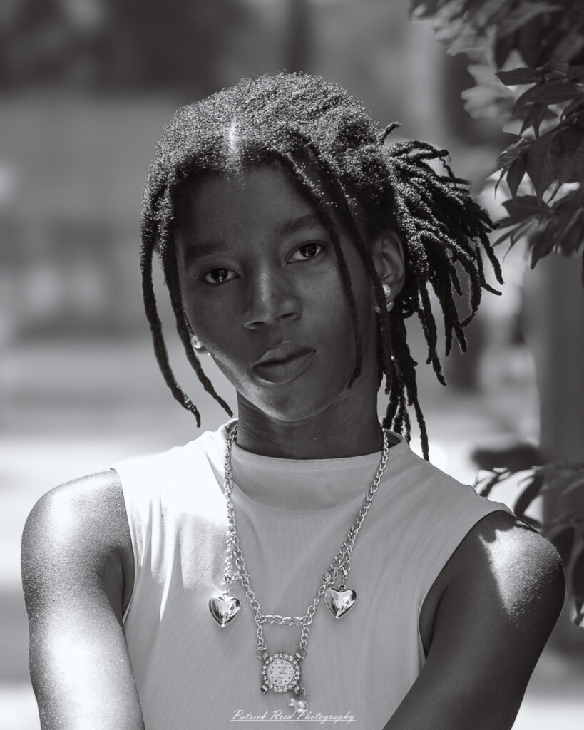 Natural light portrait of a model, photographed on June 28, 2025. She is posed outdoors with soft, flattering lighting, conveying a calm and confident expression.